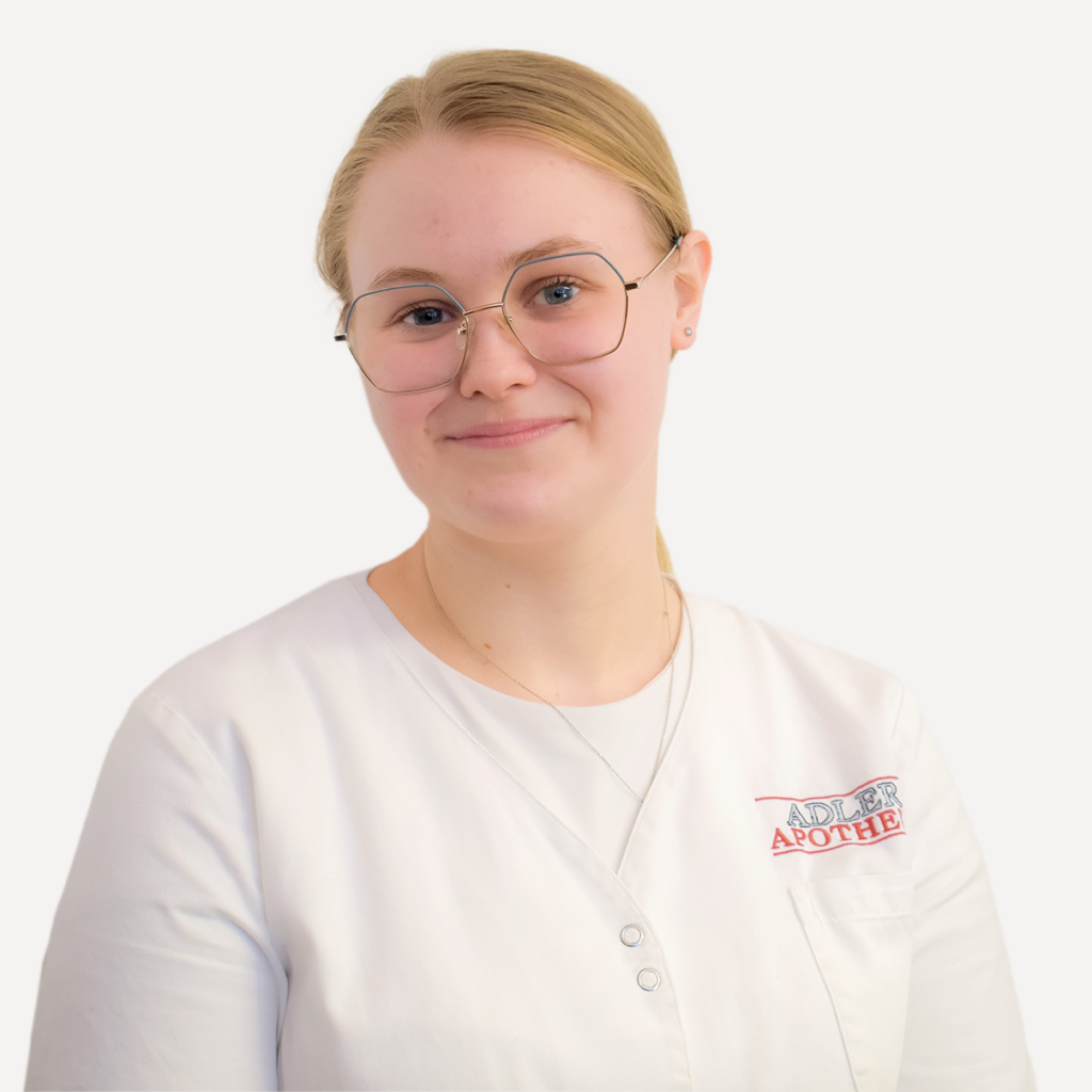 Die Mitarbeiterin der Adler Apotheke Sarah Müller in einem weißen Apothekermantel.