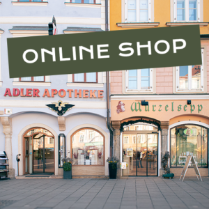 Die Außenansicht der Adler Apotheke und des Wurzelsepp in Graz mit einem darübergelegten dunkelgrünen Balken und der Aufschrift „ONLINE SHOP“.